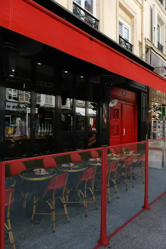 Installation d'un système de paravents fixes devant l'établissement d'une brasserie.